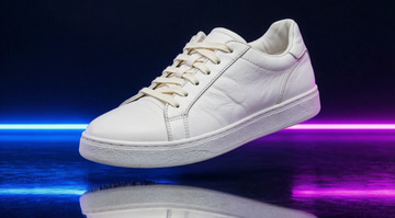 Imagera Warrior Edit sample: A muddy, scuffed white leather sneaker cleaned with no trace left, same shoe and same neon studio light