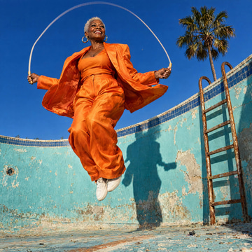 ChatGPT 2.5 Flare sample: A silver-haired woman in a tangerine suit leaps rope inside a drained turquoise pool.