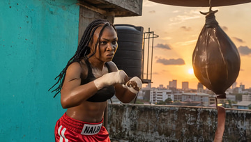 Flux 3 sample: A boxer hammers a speed bag on a sunset Lagos rooftop, its rattle ringing out.