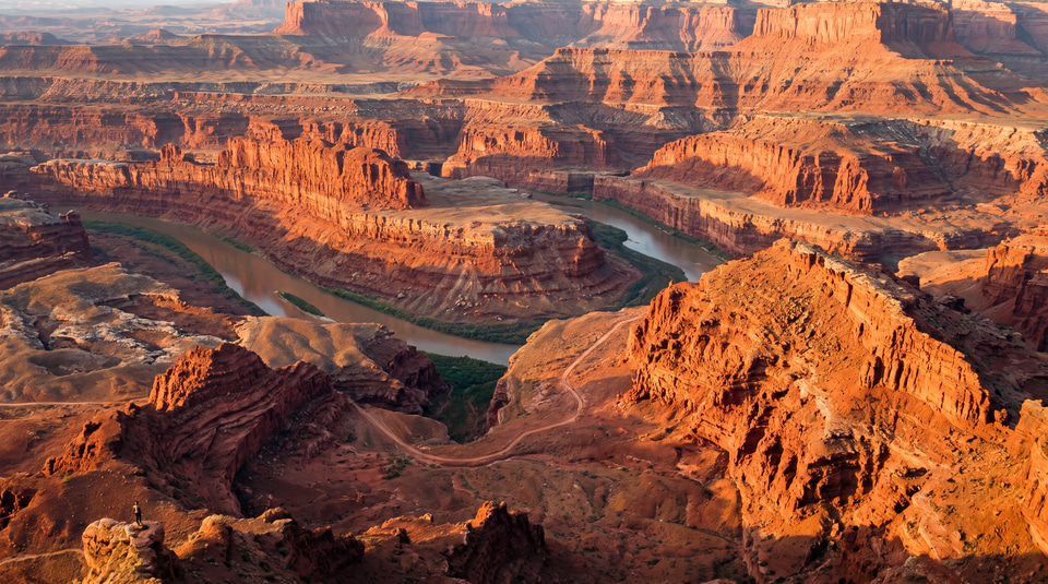 A river winding through red sandstone canyons at golden hour